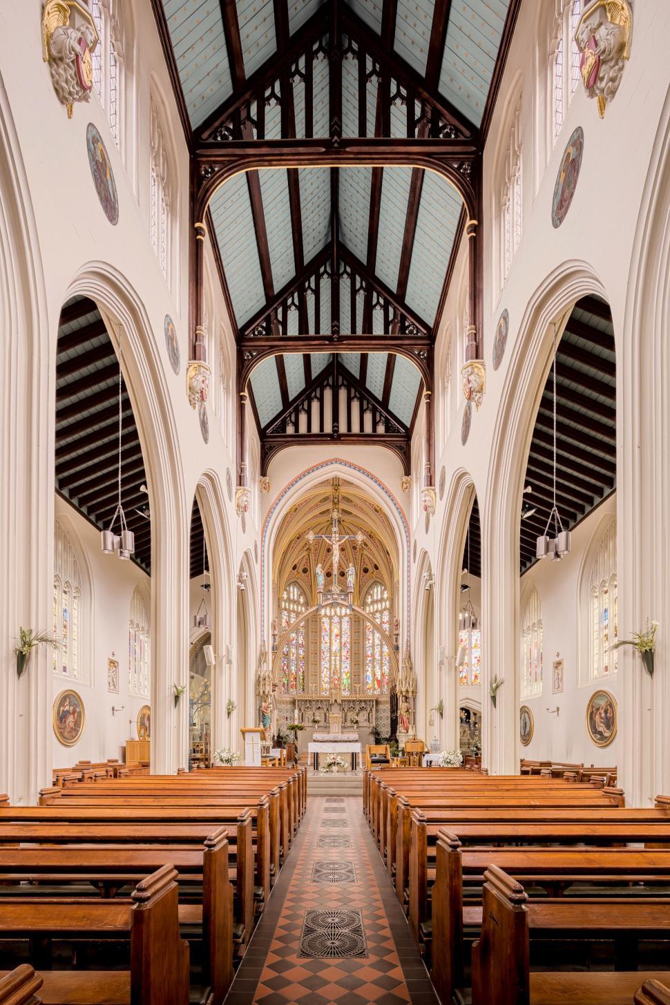 Free Image of Church Interior With Pews and Checkered Floor 