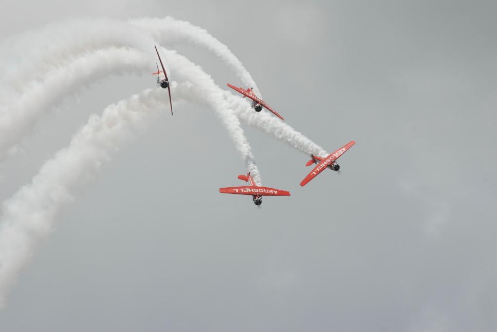 Free Image of Group of Red Airplanes Flying Through the Sky 