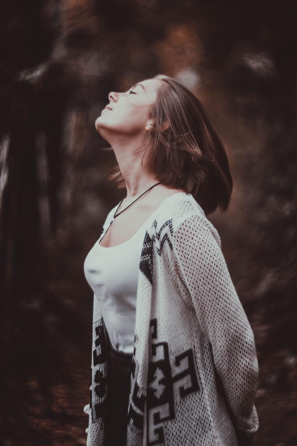 Free Image of Woman Standing With Closed Eyes in the Woods 