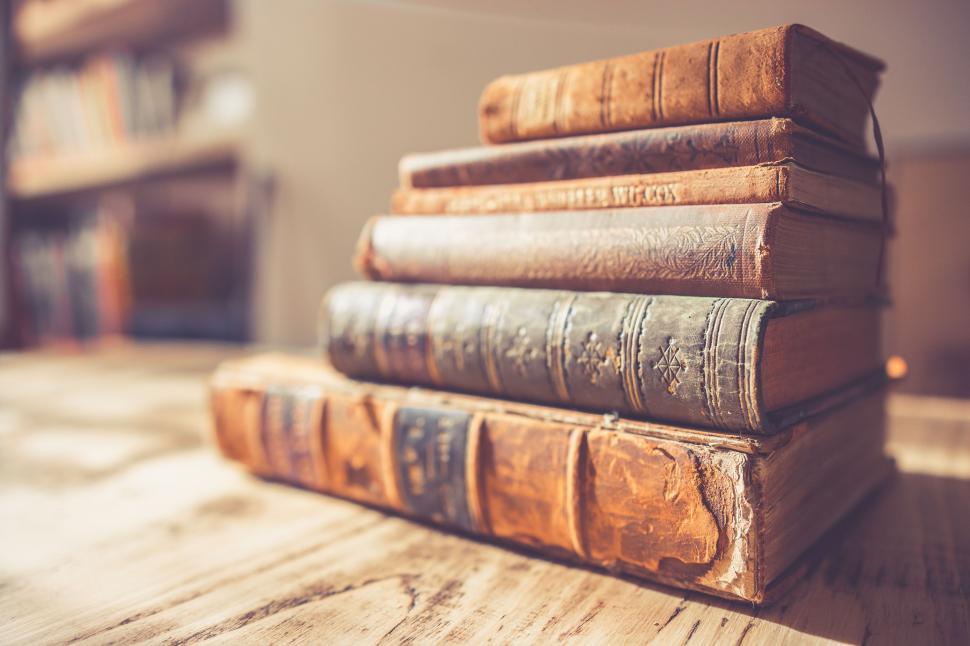 Free Image of Stack of Old Books on Wooden Table 