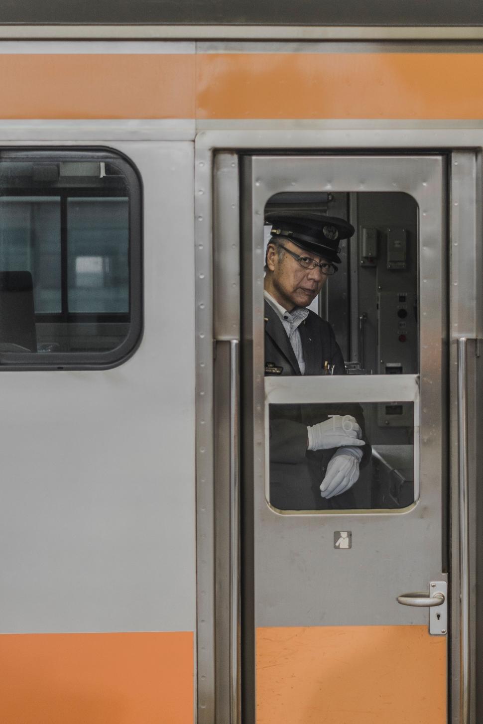 Free Image of Man in Suit and Hat on Train 