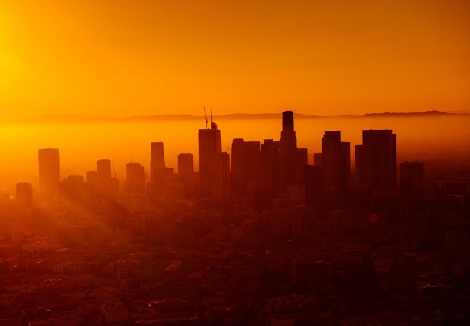 Free Image of Sun Setting Over City Skyline 