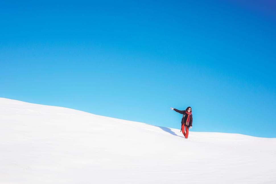 Free Image of Person Standing on Snow Covered Hill 