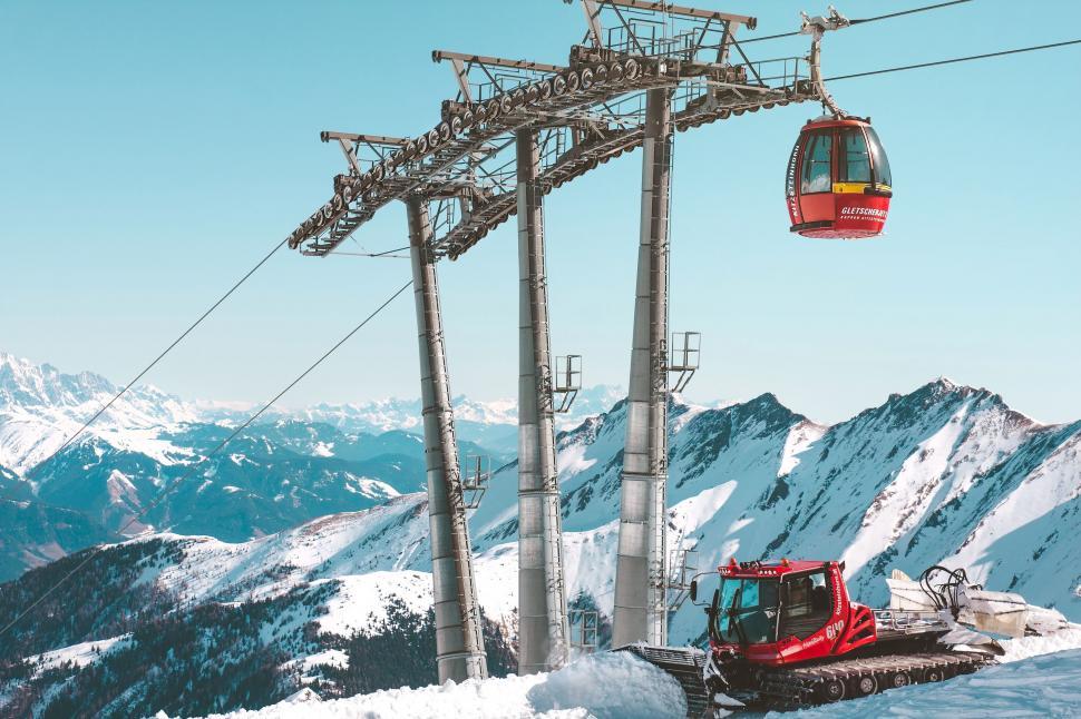 Free Image of Ski Lift Crossing Snow Covered Mountain 