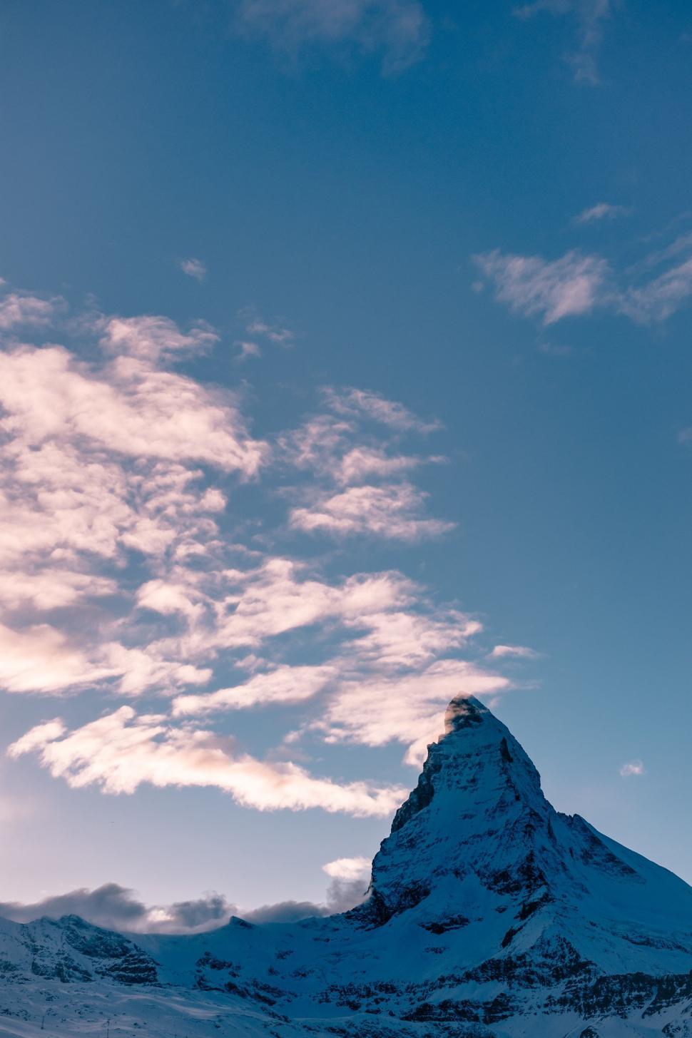 Free Image of Snow Covered Mountain Under Cloudy Blue Sky 