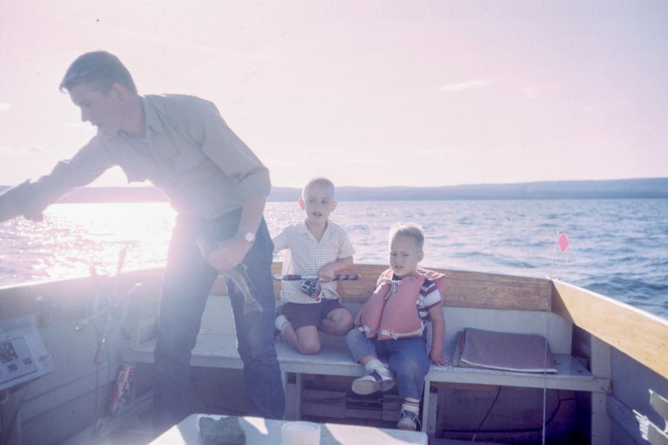 Free Image of Man and Two Children on a Boat 