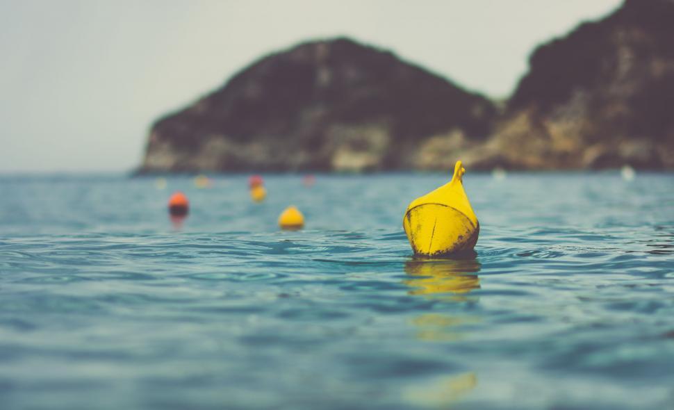 Free Image of Yellow Object Floating on Body of Water 