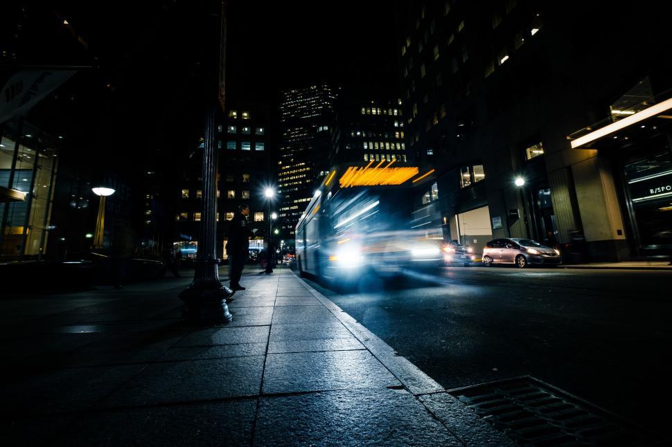Free Image of Bus Driving Down City Street at Night 