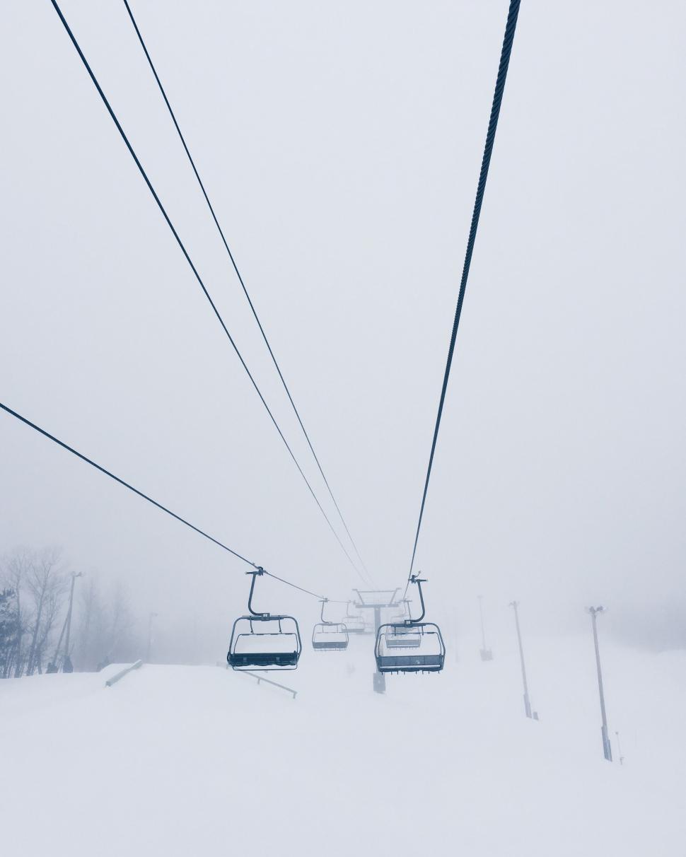 Free Image of Ski Lift With Two People in Snow 