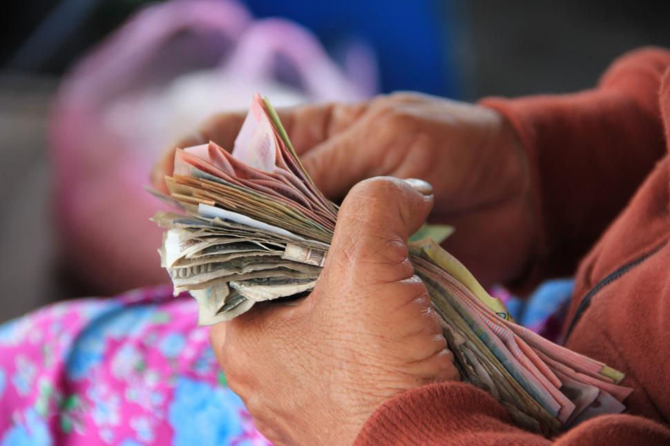 Free Image of Person Holding a Bunch of Money 