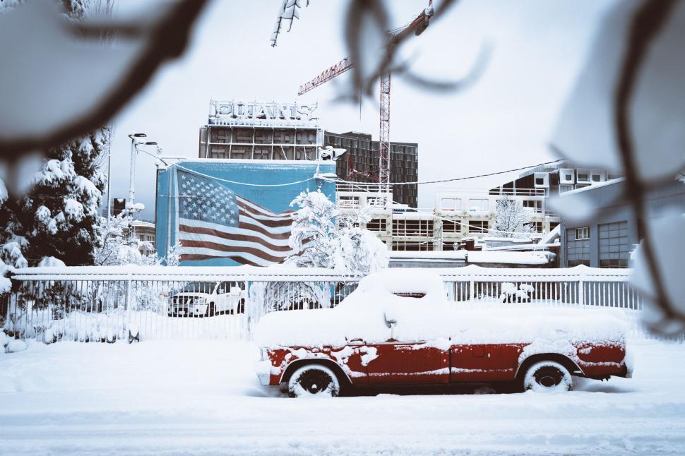 Free Image of Car Covered in Snow in Front of Building 