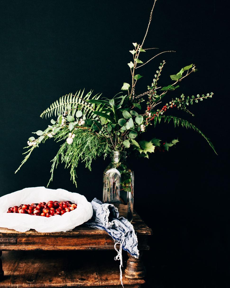 Free Image of Vase of Flowers and Berries on Table 