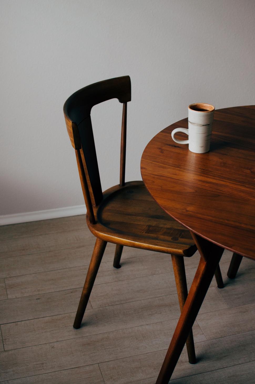 Free Image of Wooden Table With Two Chairs and Cup 