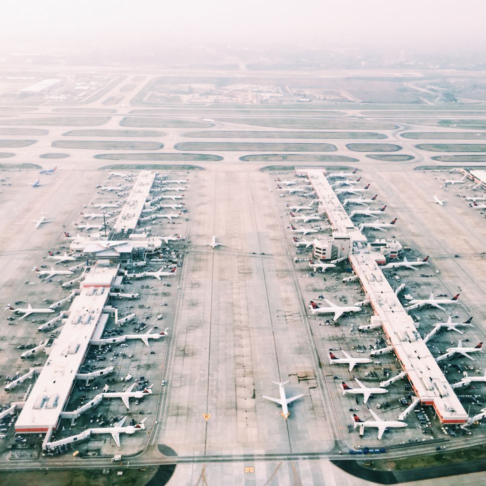Free Image of Busy Airport Apron Filled With Numerous Parked Airplanes 