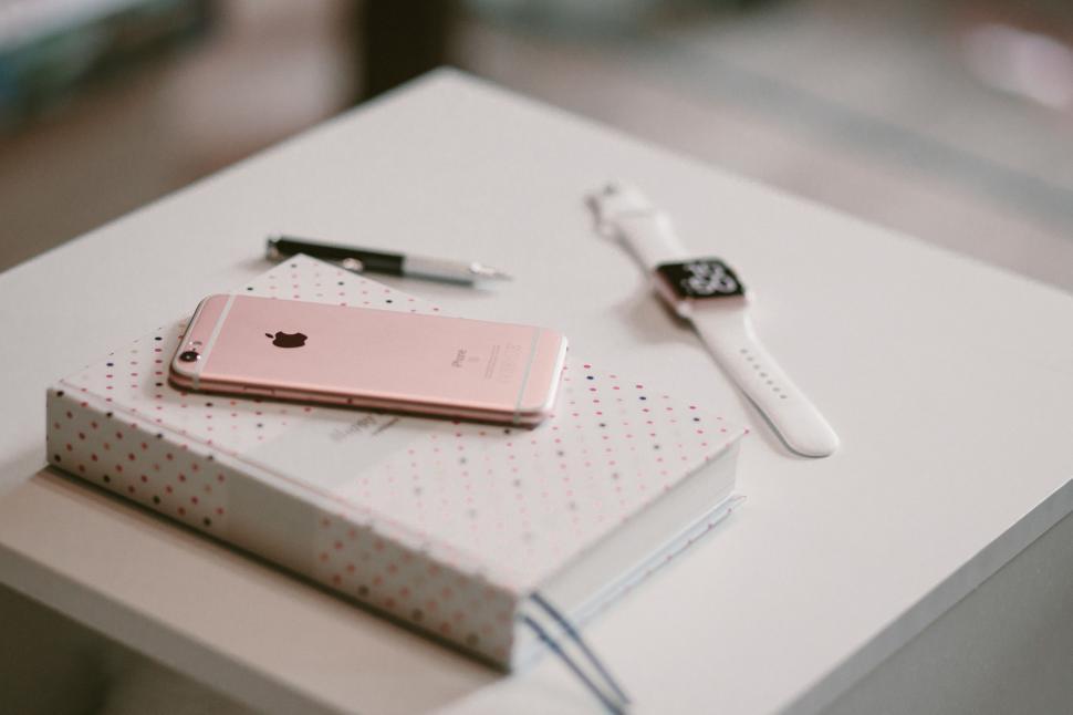 Free Image of White Table With Cell Phone and Pen 