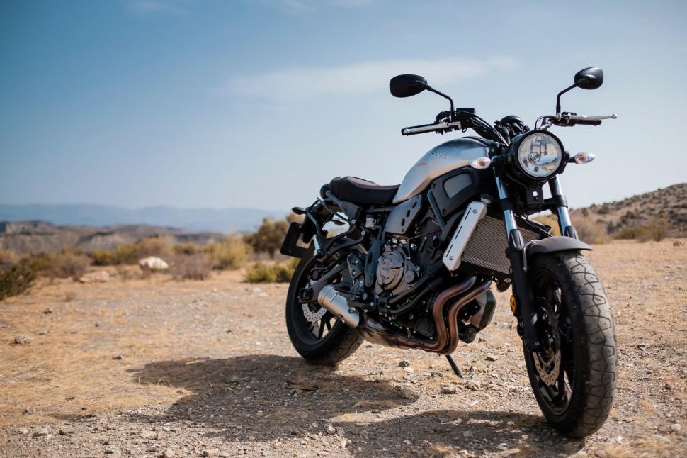 Free Image of Motorcycle Parked on Dirt Road in Desert 