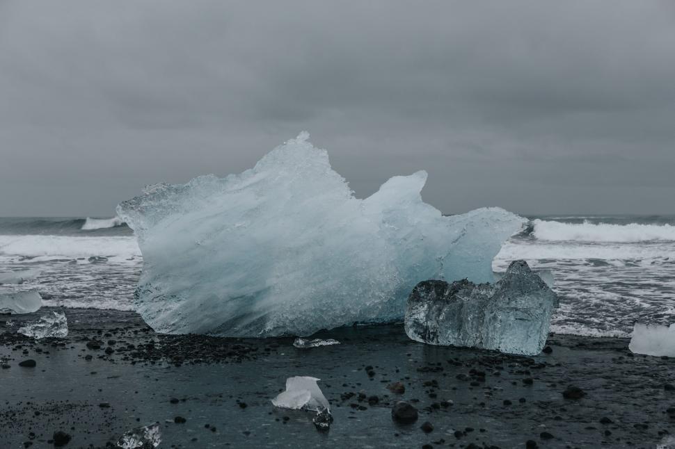 Free Image of Massive Iceberg Bobbing on Body of Water 