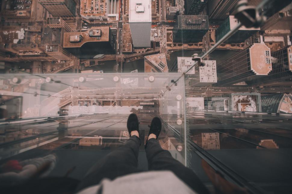 Free Image of Person Sitting on Ledge With Feet in the Air 