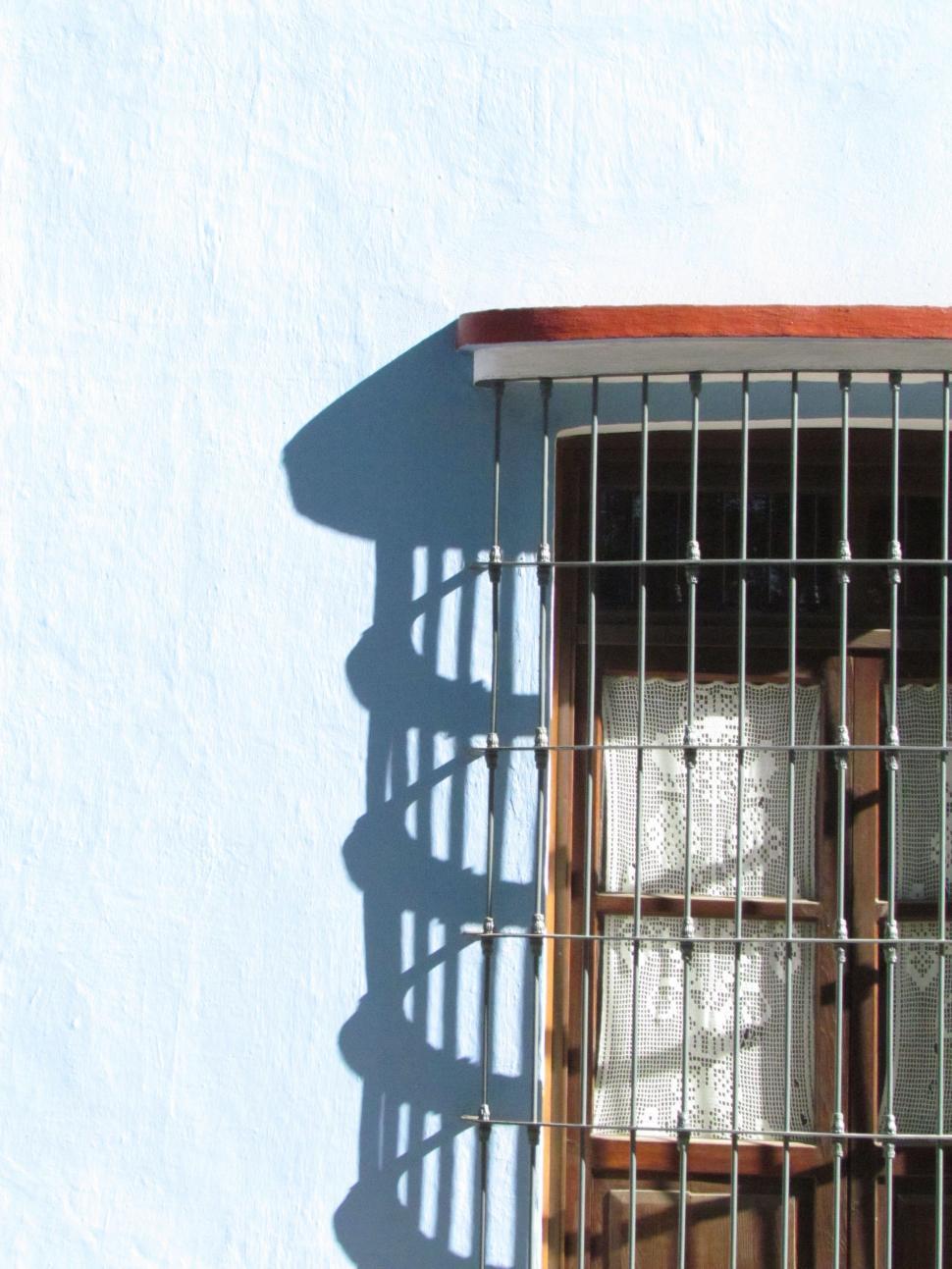 Free Image of Window With Bars on the Outside 