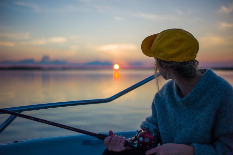 Free Image of Woman Sitting on a Boat in the Water 