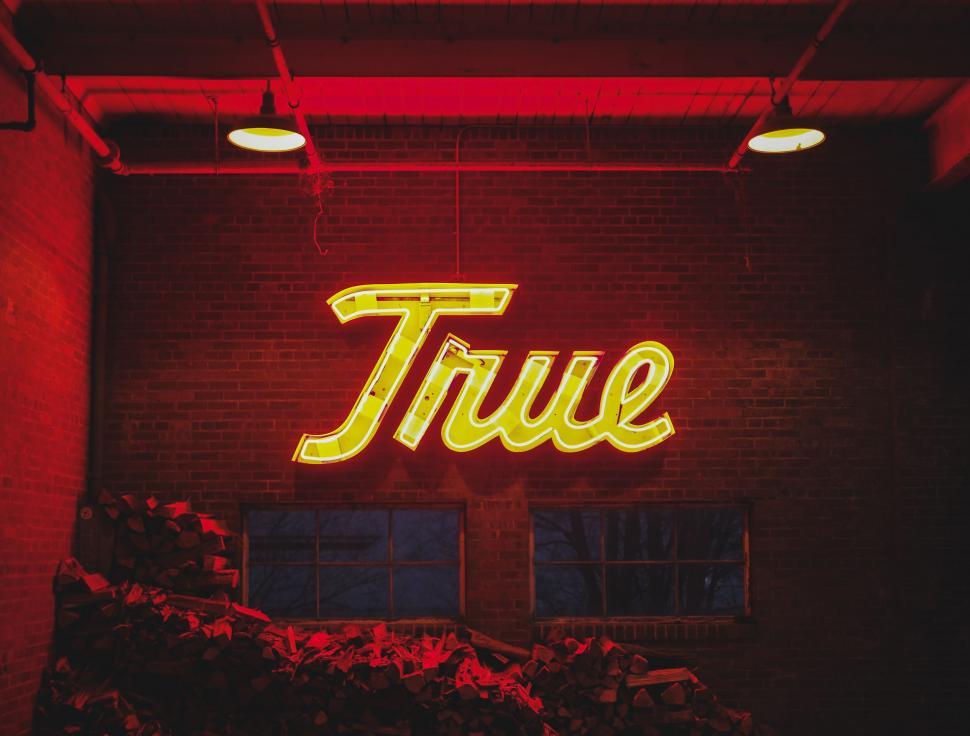 Free Image of Neon Sign Saying True on Building 
