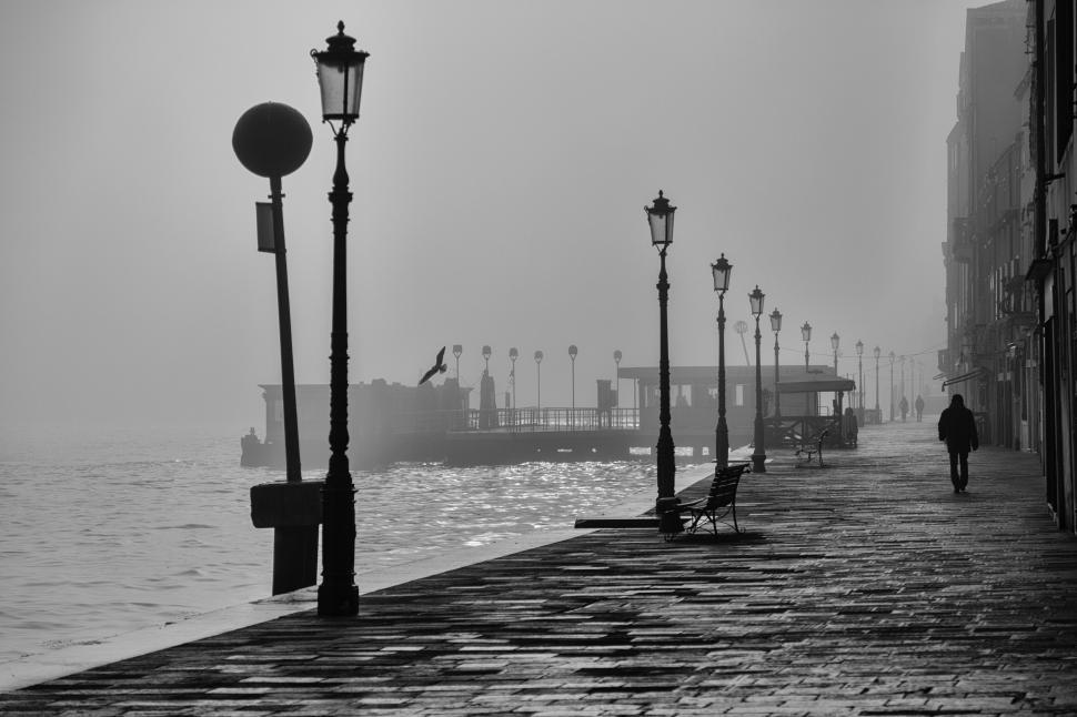Free Image of Person Walking on Pier 