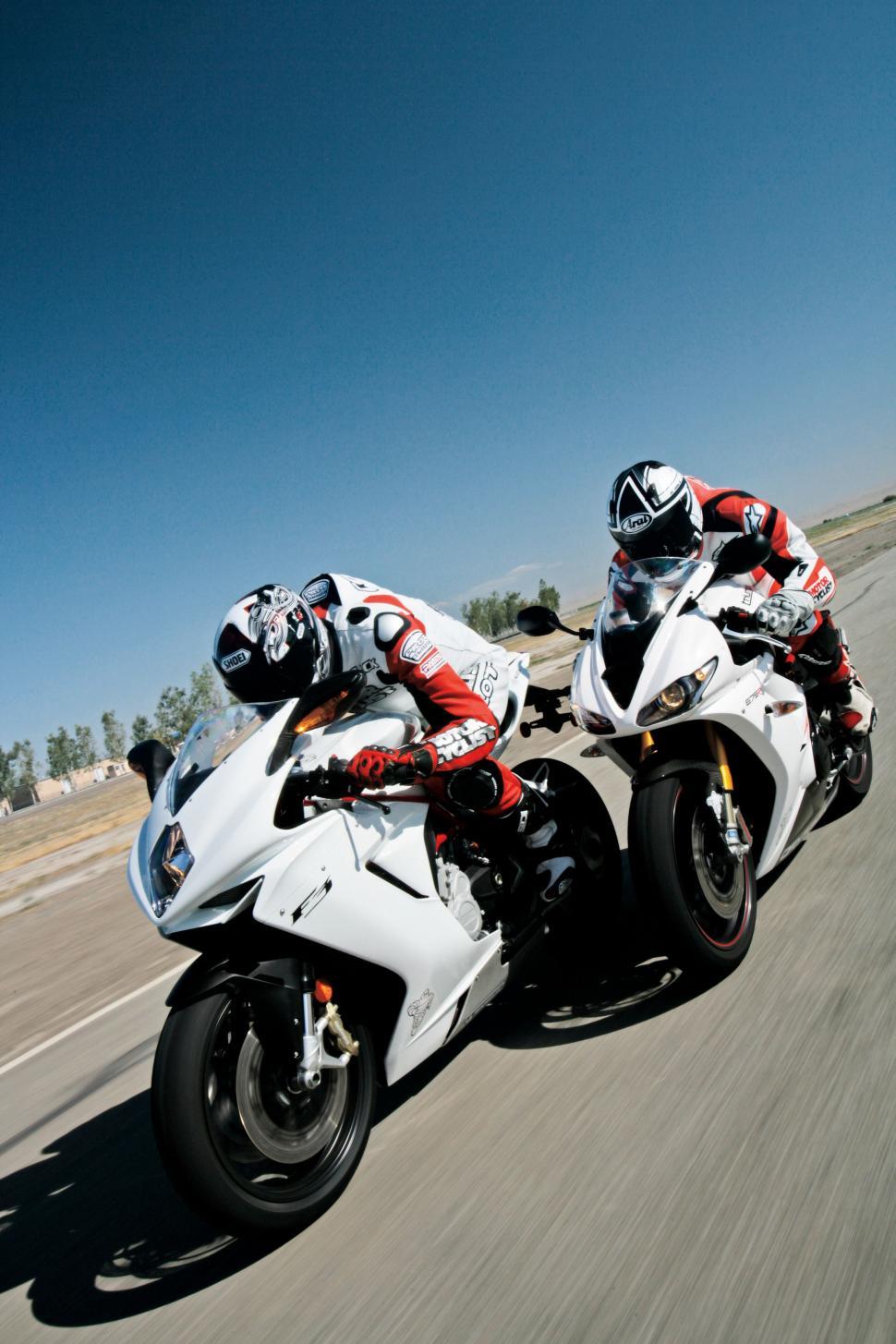 Free Image of Two People Riding Motorcycles on a Road 