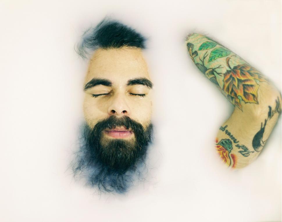 Free Image of Bearded Man With Tattooed Arm 