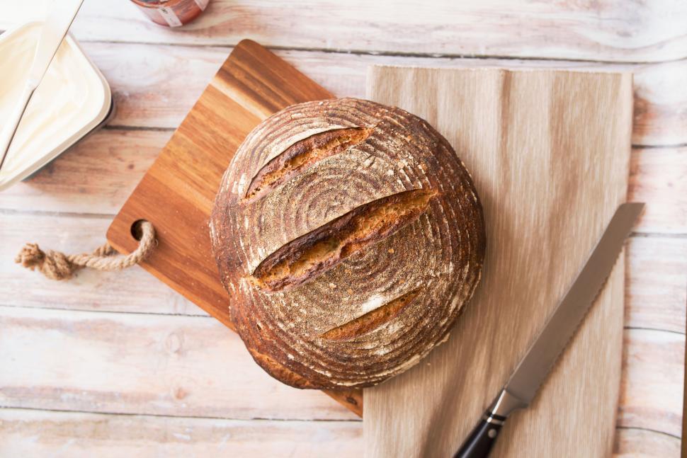 Free Image of Loaf of Bread on Cutting Board With Knife 