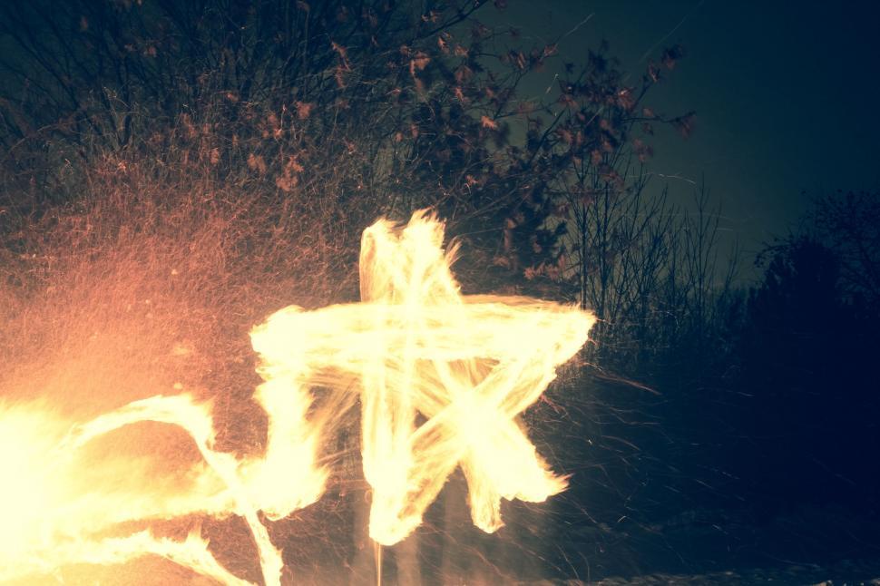 Free Image of Person Standing in Front of Cross on Fire 