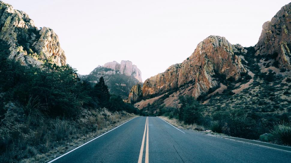 Free Image of Empty Road Surrounded by Mountains 