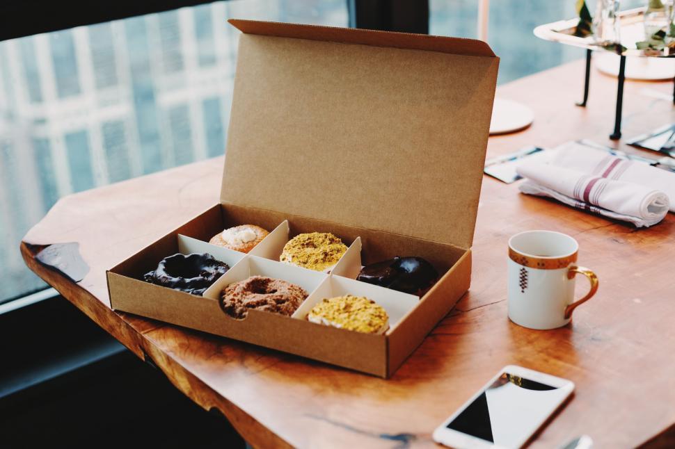 Free Image of Box of Donuts and Coffee Cup on Table 