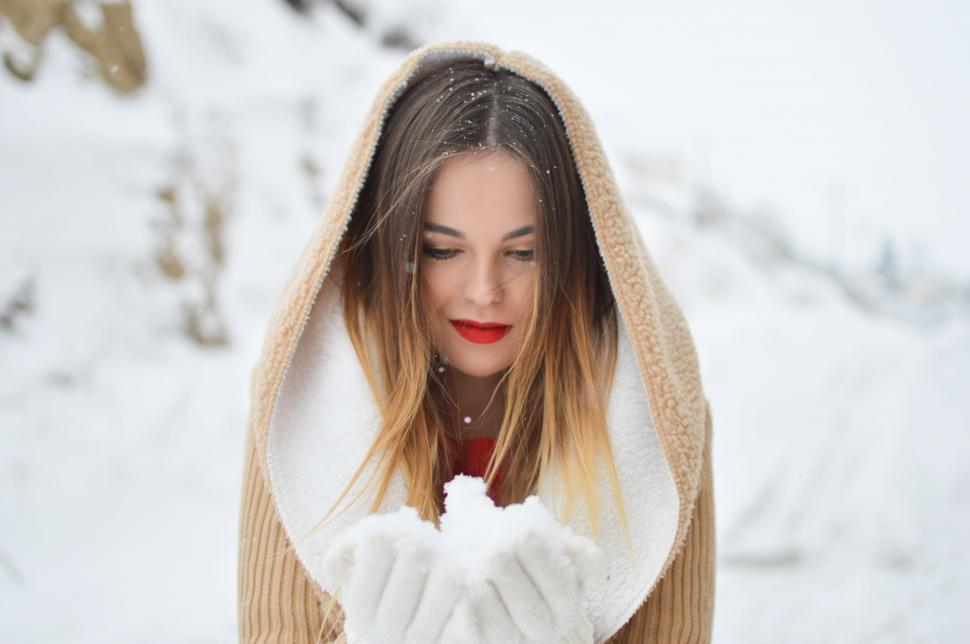 Free Image of Woman With Long Hair Holding Snowball 