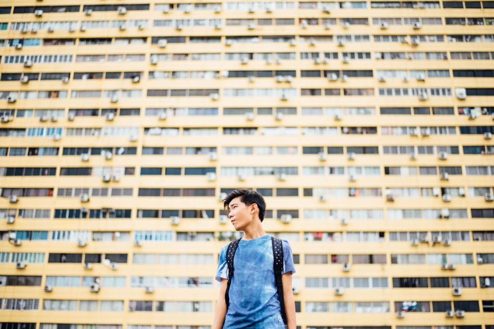 Free Image of Man Standing in Front of Tall Building 