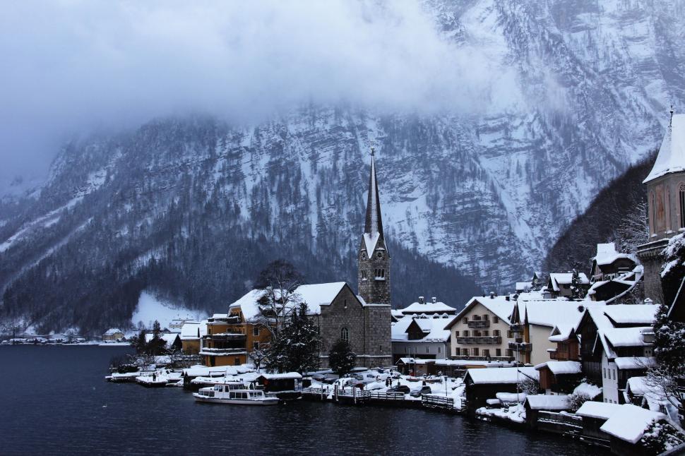 Free Image of Snowy Village on Lake With Mountains 