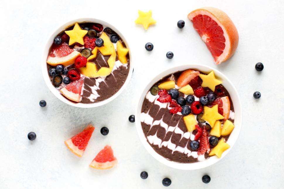 Free Image of Two Bowls Filled With Fruit and Topped With Chocolate 