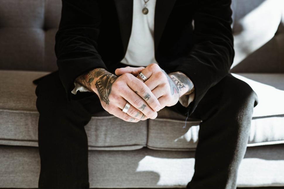 Free Image of Man in Suit Sitting on Couch 