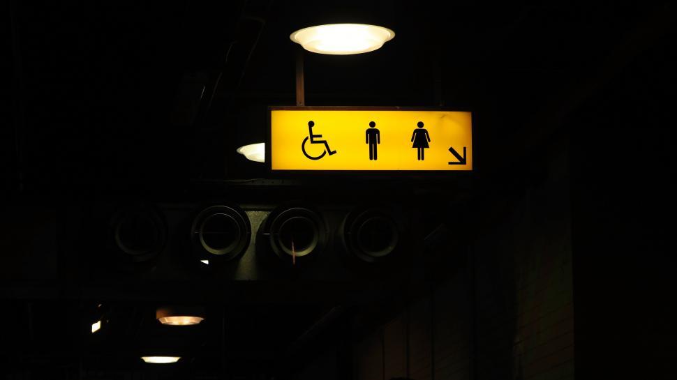 Free Image of Yellow Sign on Pole in Dark Room 
