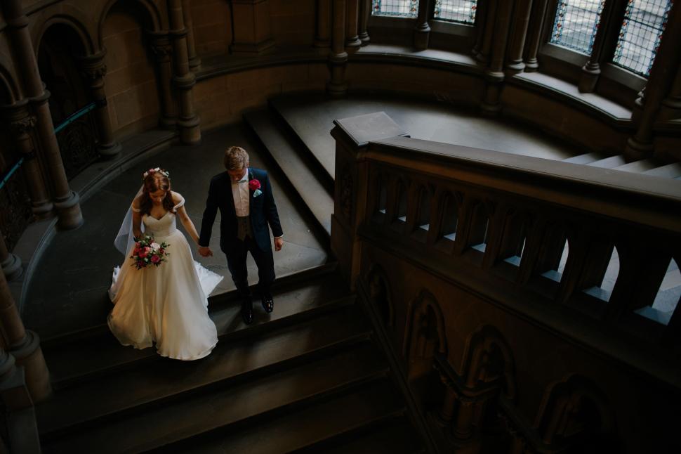Free Image of Bride and Groom Walking Down the Stairs 
