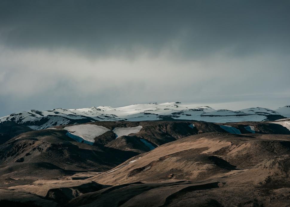 Free Image of Snow-covered Mountain Beneath Overcast Sky 