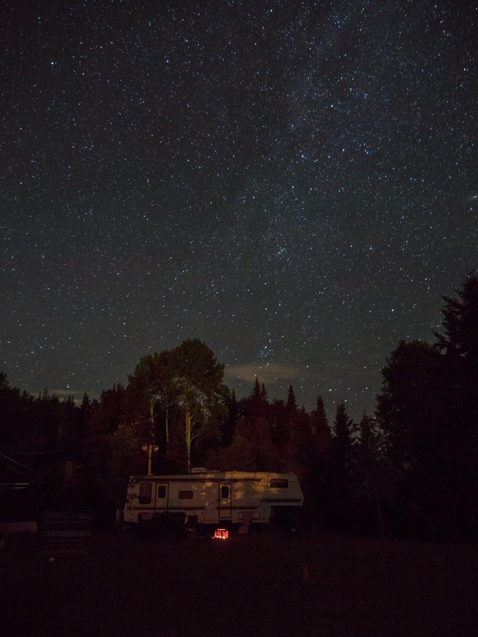 Free Image of Trailer Parked in Field Under Starry Night Sky 