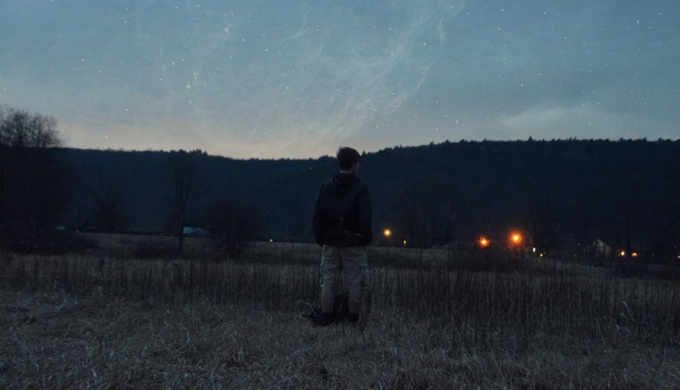 Free Image of Person Standing in Field at Night 