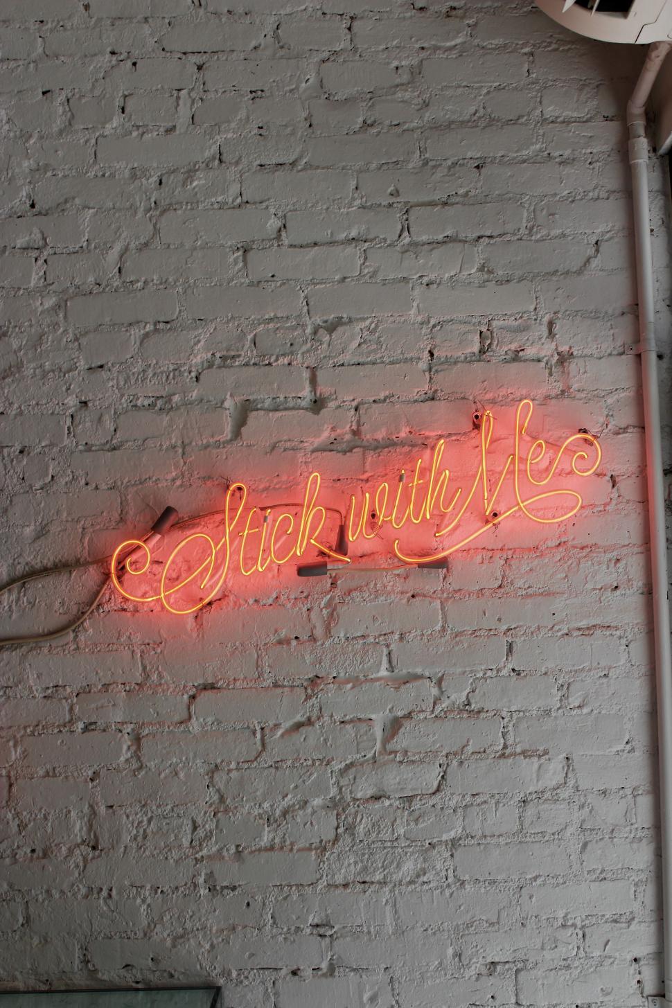 Free Image of Neon Sign on Brick Wall: Stick With Me 