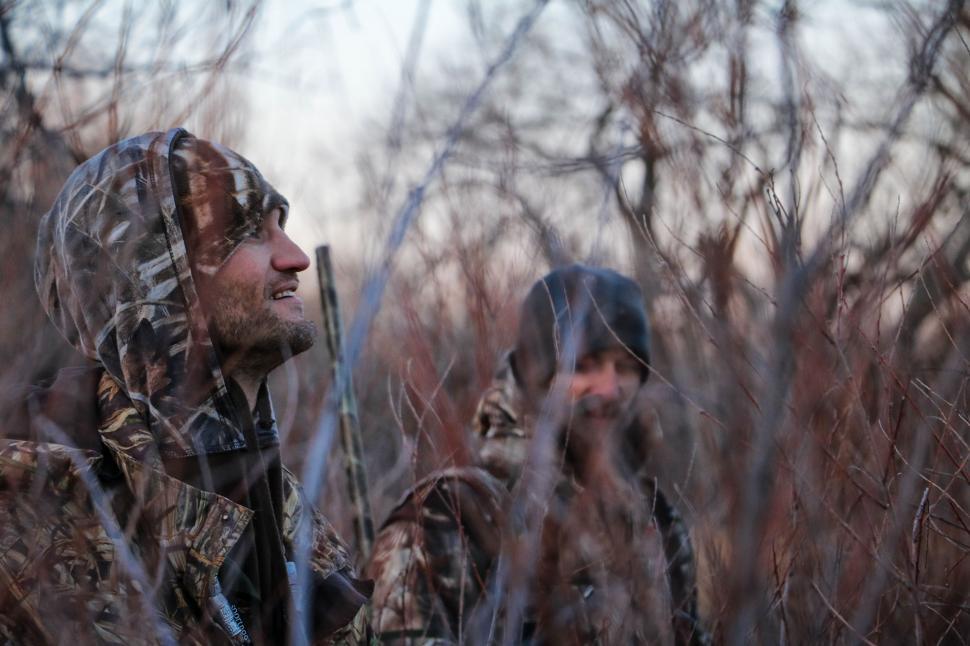Free Image of Two Men in Camouflage Clothing Standing in Tall Grass 