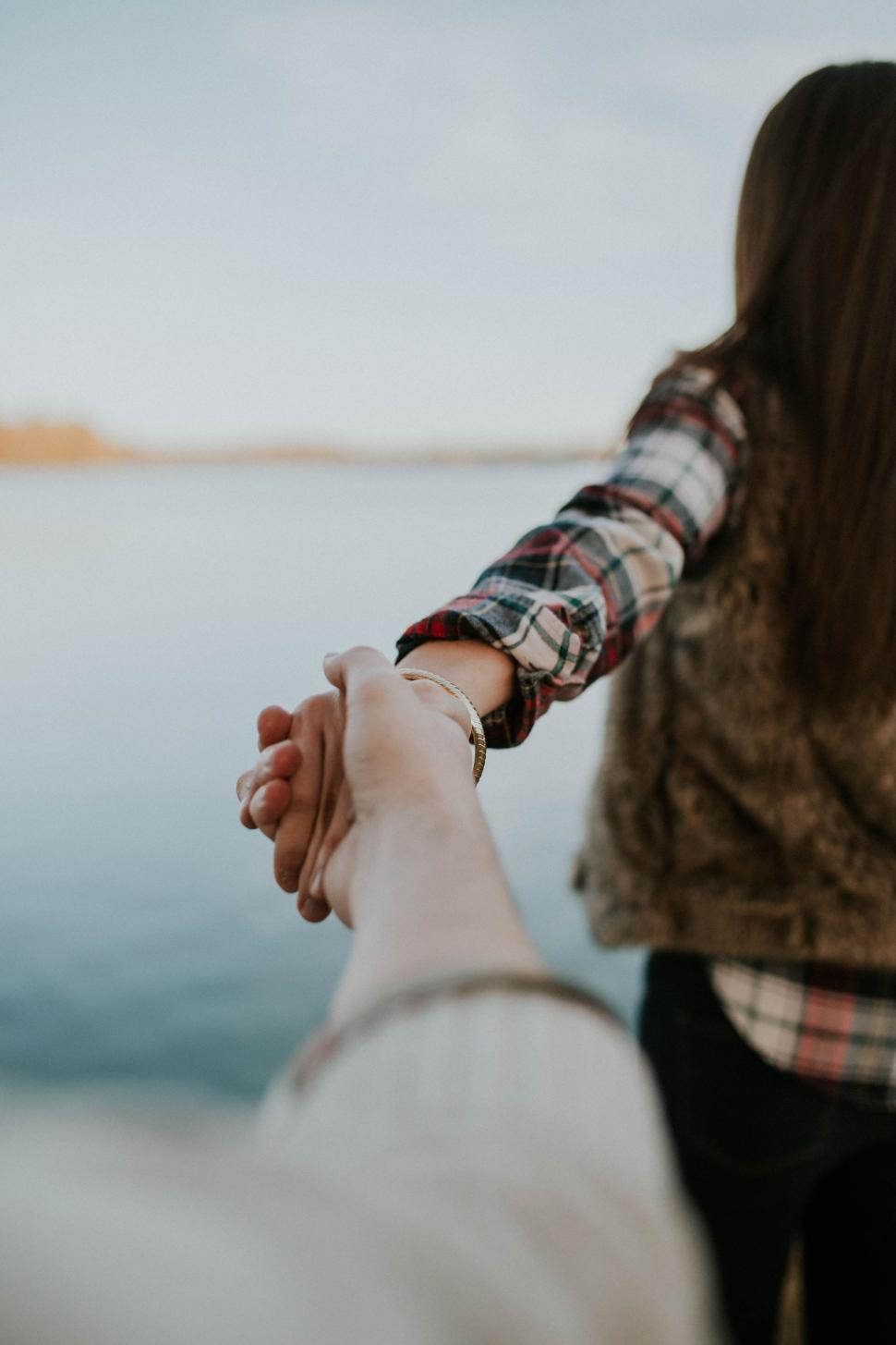 Free Image of A Couple Holding Hands While Standing Together 