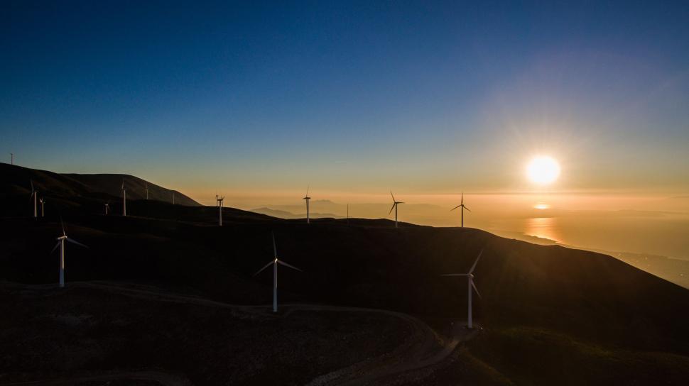 Free Image of Group of Windmills on Hill at Sunset 