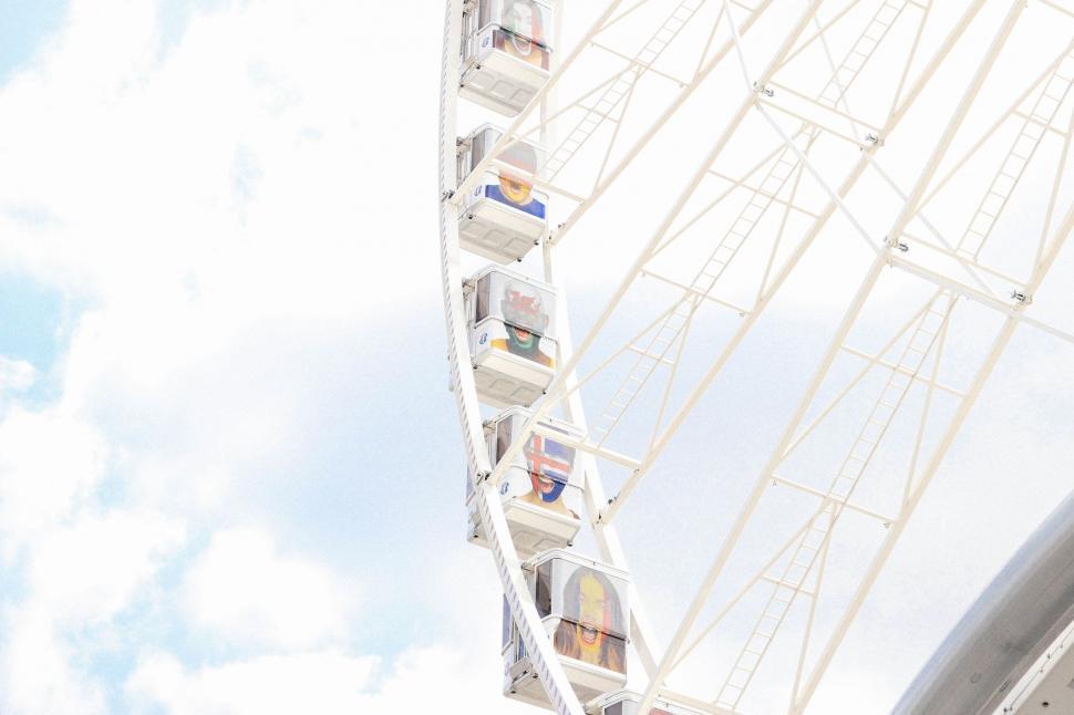 Free Image of People Riding Ferris Wheel Against Blue Sky 
