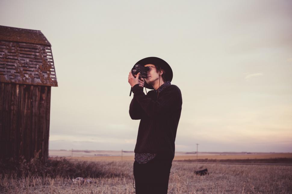 Free Image of Man Standing in Field With Hat On 