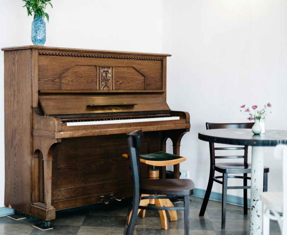Free Image of Wooden Piano Beside Table in Room 