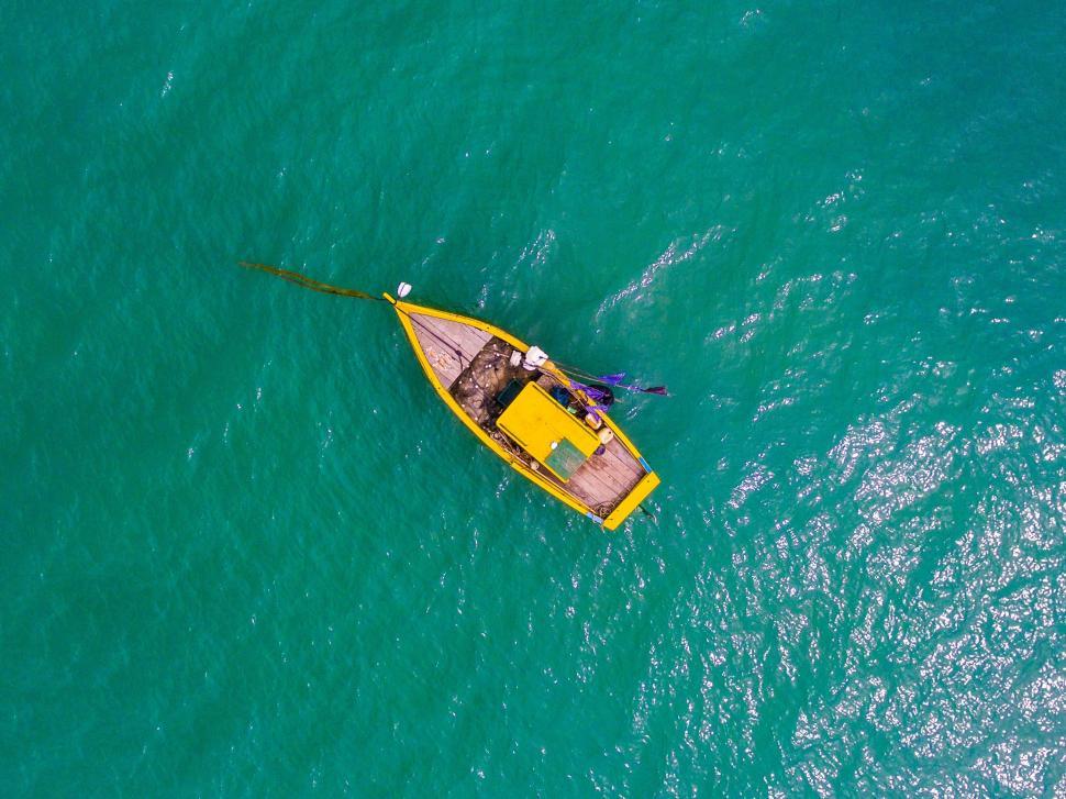 Free Image of Yellow Boat Floating on Blue Ocean 
